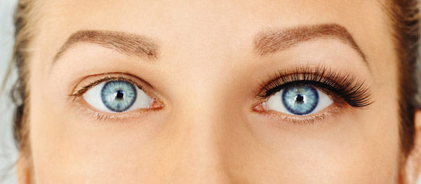 Close up of a woman's eyes before and after eyelash extensions at The Facial Center in Charleston, WV