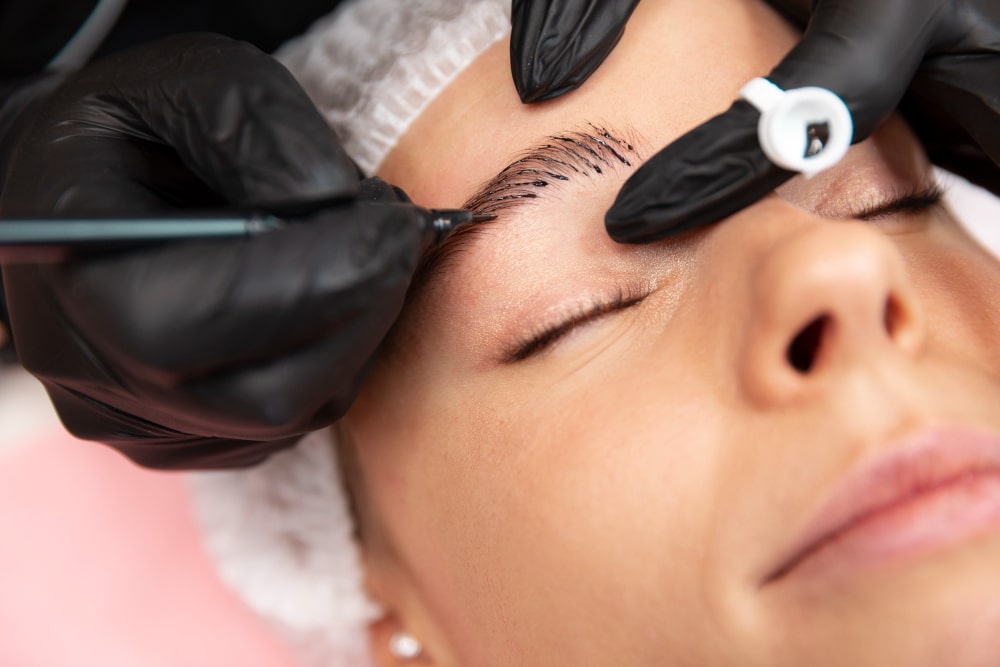 Beautiful young woman receiving microblading treatment from The Facial Center in Hurricane, WV