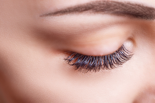 Closeup of woman looking down with her beautiful eyelash extensions from The Facial Center in Hurricane, WV